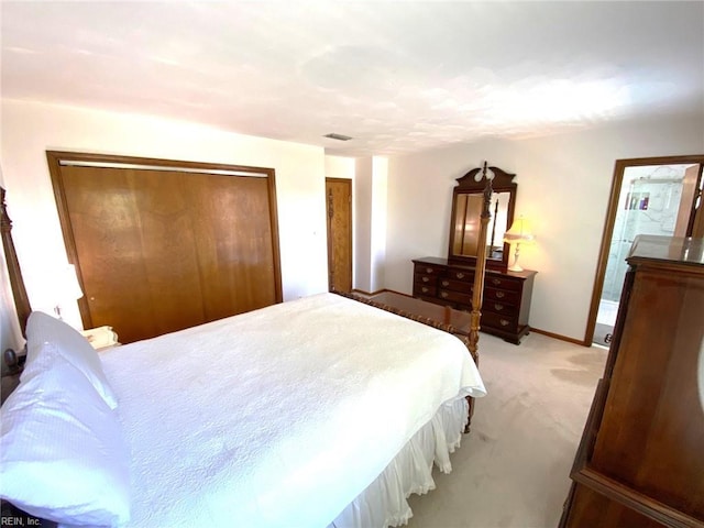 bedroom with baseboards, visible vents, and light carpet