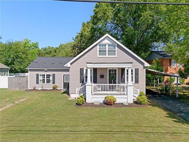 bungalow with covered porch, fence, a front lawn, and aphalt driveway