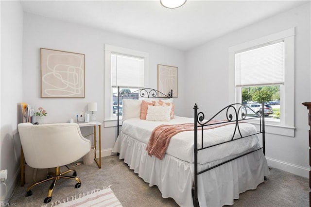 bedroom with baseboards and light carpet