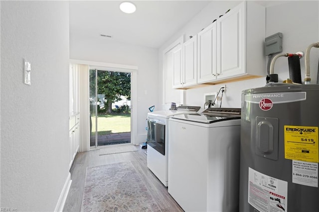 laundry area featuring cabinet space, light wood-type flooring, visible vents, washing machine and dryer, and electric water heater