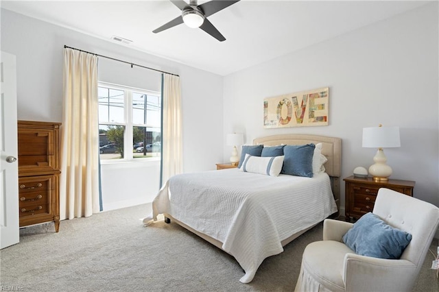 carpeted bedroom with ceiling fan and visible vents