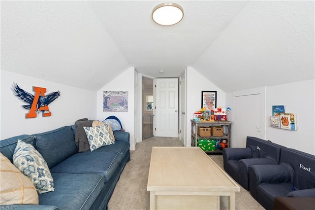 living area with light colored carpet, a textured ceiling, and lofted ceiling