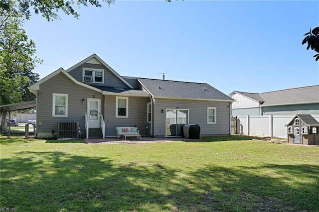rear view of property featuring a fenced backyard, a patio, and a lawn