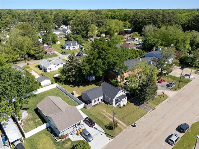 bird's eye view featuring a wooded view and a residential view