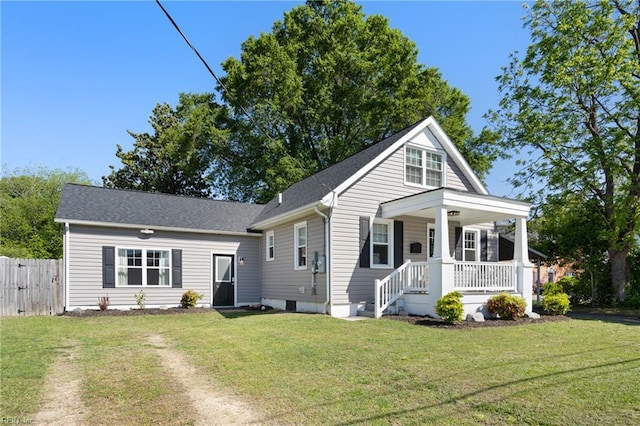bungalow with a front lawn, fence, and covered porch