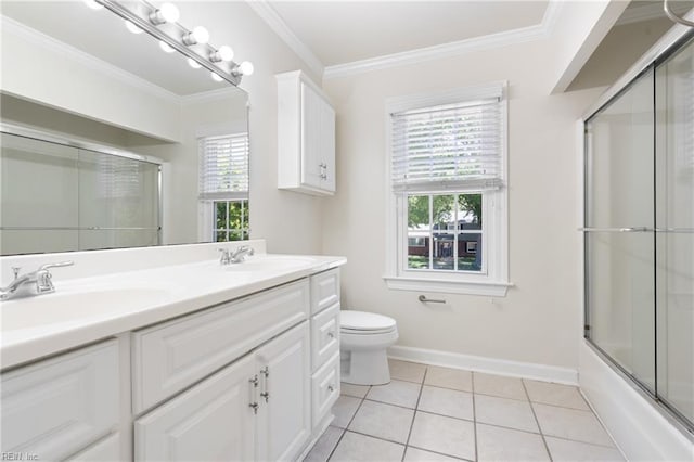 full bath featuring toilet, double vanity, baseboards, and a sink