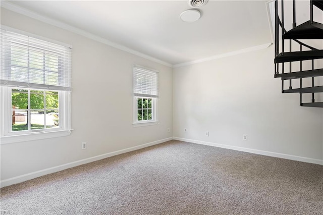 carpeted spare room with crown molding and baseboards