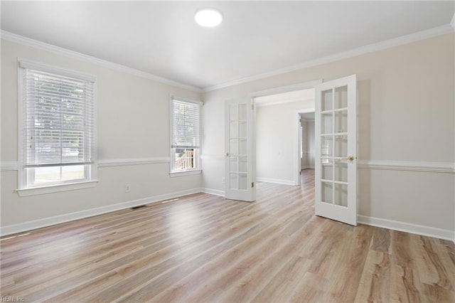 unfurnished room with french doors, ornamental molding, light wood-style floors, and baseboards