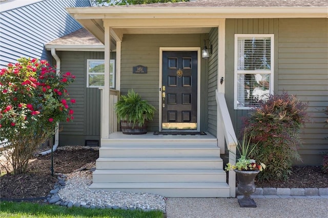property entrance featuring roof with shingles