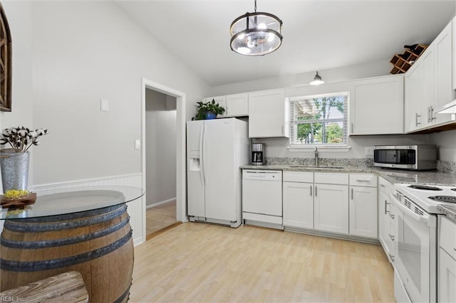 kitchen featuring a sink, light stone counters, light wood-style floors, white appliances, and white cabinetry