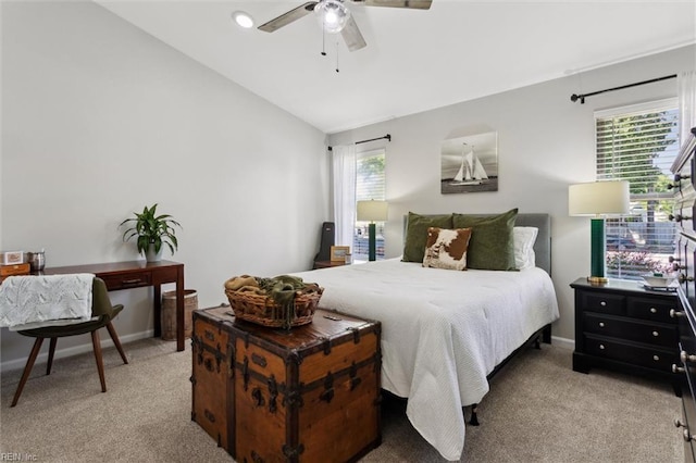 bedroom with light colored carpet, baseboards, ceiling fan, and vaulted ceiling
