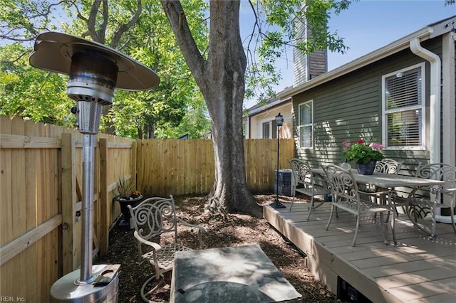 exterior space featuring fence, central AC unit, and outdoor dining area