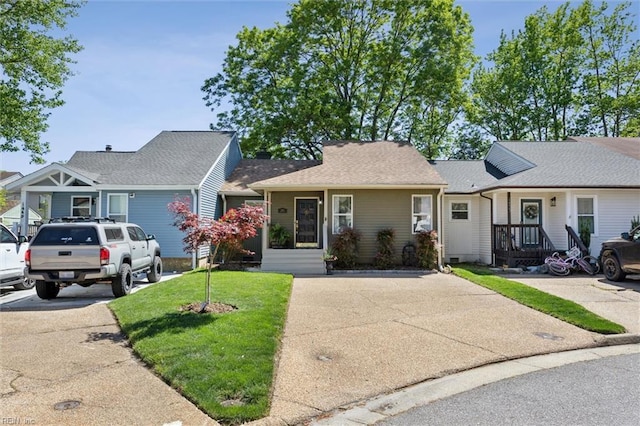 view of front of house with concrete driveway and a front yard