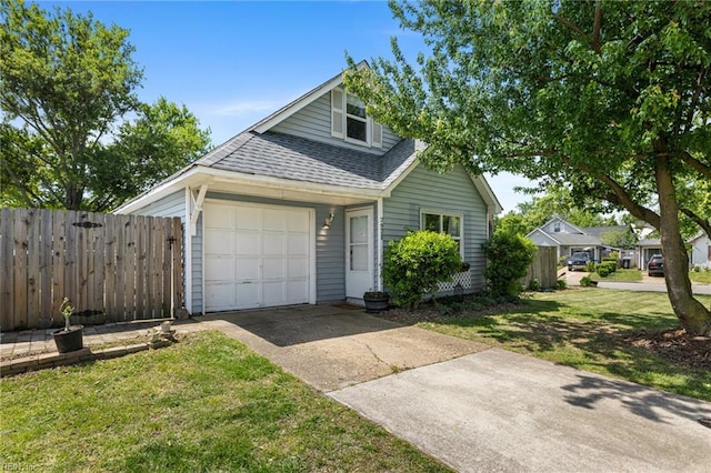 view of front facade featuring an attached garage, roof with shingles, fence, and driveway