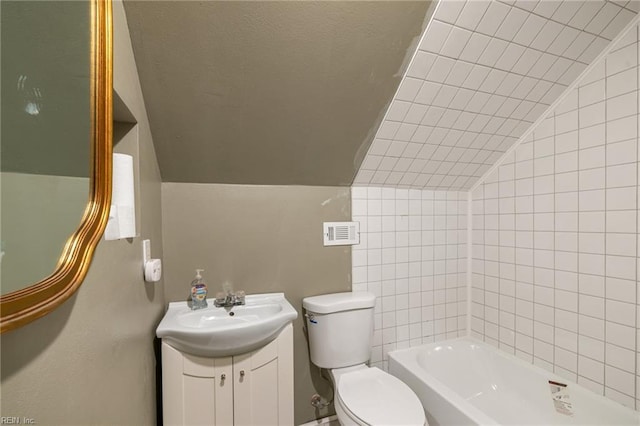 bathroom featuring toilet, vaulted ceiling, visible vents, and vanity