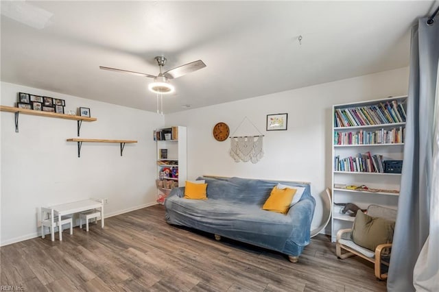 sitting room featuring baseboards, ceiling fan, and wood finished floors