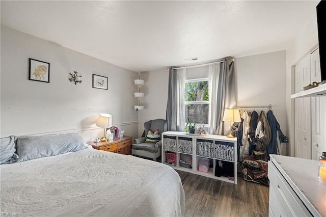 bedroom with visible vents and dark wood-style floors
