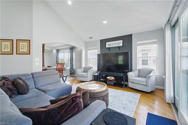 828 Vanderbilt Ave, Virginia Beach, VA 23451 - living room featuring light wood-style floors, arched walkways, recessed lighting, and high vaulted ceiling