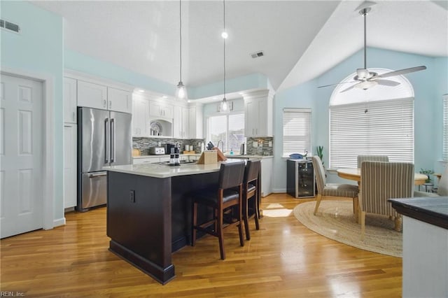 828 Vanderbilt Ave, Virginia Beach, VA 23451 - kitchen with high end refrigerator, ceiling fan, white cabinets, and vaulted ceiling
