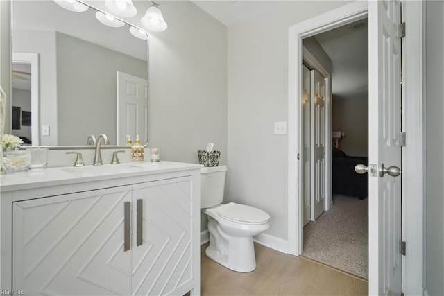 828 Vanderbilt Ave, Virginia Beach, VA 23451 - bathroom featuring vanity, baseboards, wood finished floors, and toilet