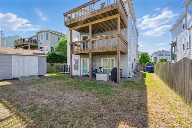 828 Vanderbilt Ave, Virginia Beach, VA 23451 - back of house featuring a lawn, a deck, an outdoor structure, and a shed