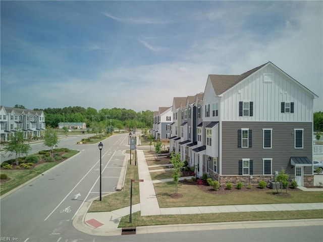view of street featuring a residential view, sidewalks, and curbs