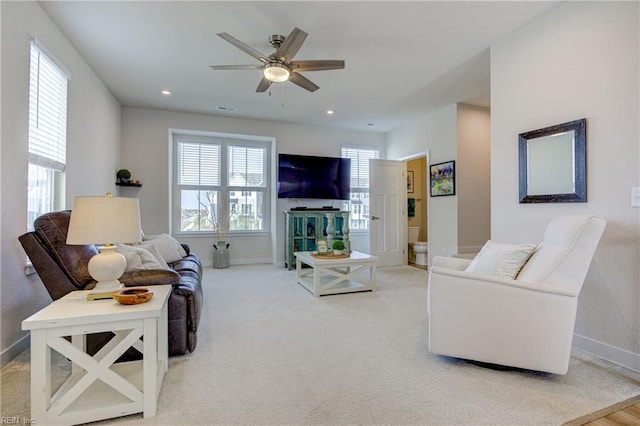 living area featuring baseboards, a ceiling fan, and recessed lighting