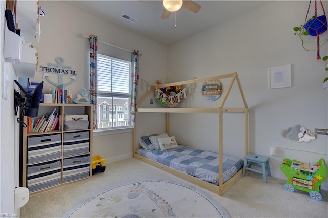 carpeted bedroom featuring visible vents and a ceiling fan