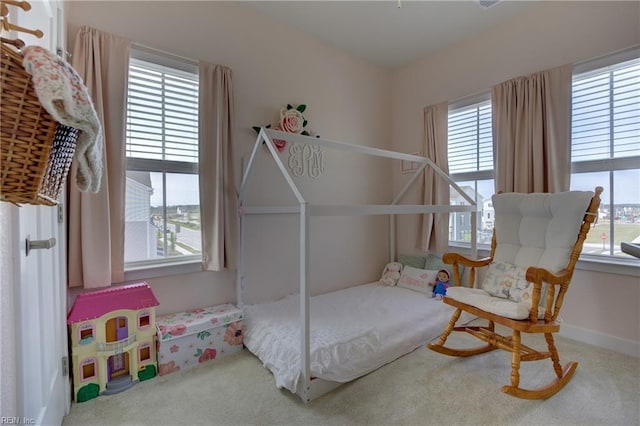 carpeted bedroom with multiple windows
