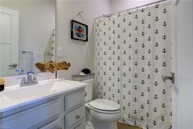 bathroom featuring vanity, a shower with shower curtain, and toilet