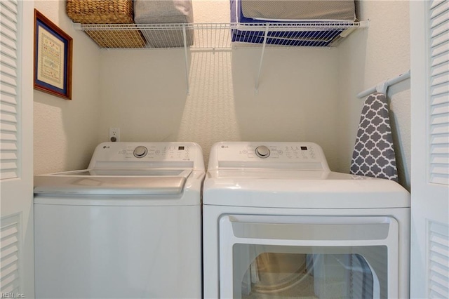 laundry room with laundry area and washing machine and clothes dryer