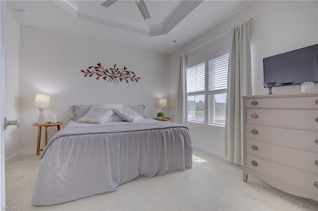 bedroom featuring a raised ceiling, baseboards, light carpet, and ceiling fan