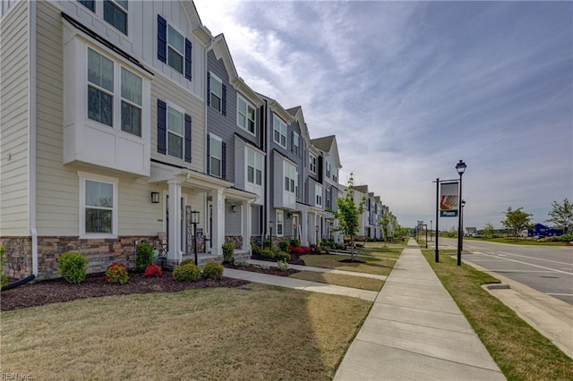 exterior space with a lawn and a residential view