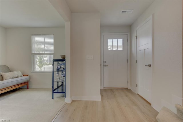 entrance foyer with visible vents, light wood finished floors, and baseboards