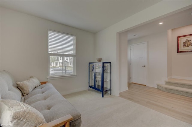 sitting room featuring baseboards, carpet flooring, stairs, and recessed lighting