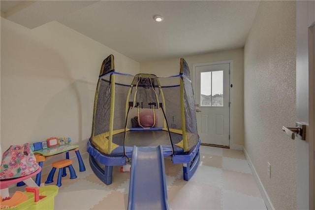 interior space featuring baseboards and tile patterned floors