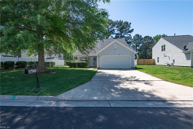 obstructed view of property with a garage, fence, a front yard, and concrete driveway