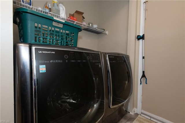 laundry room featuring separate washer and dryer, laundry area, and baseboards