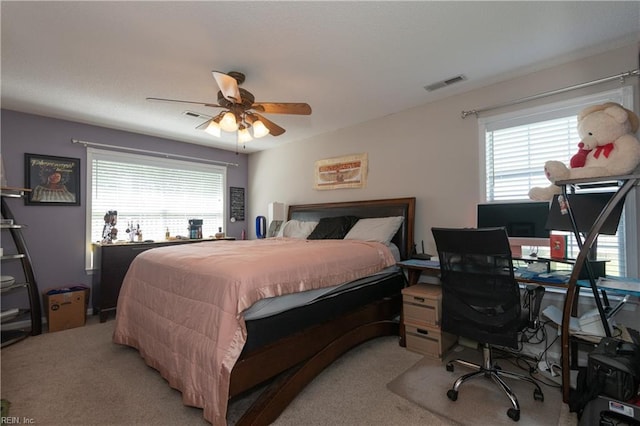 bedroom with multiple windows, light carpet, and visible vents