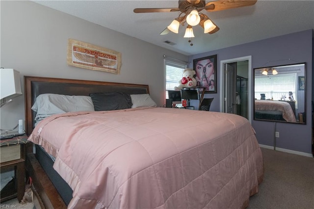 bedroom with carpet flooring, baseboards, visible vents, and ceiling fan