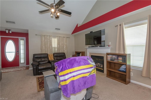 living area with carpet floors, a ceiling fan, lofted ceiling, and visible vents