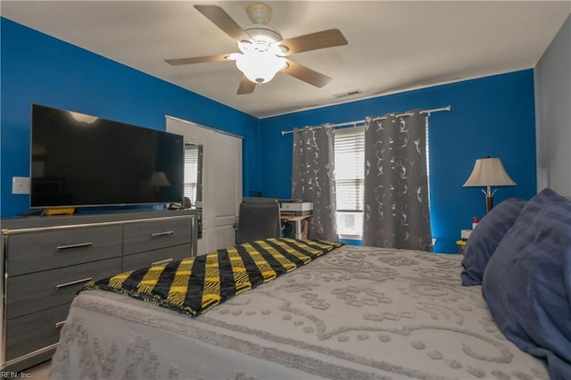 bedroom with ceiling fan and visible vents