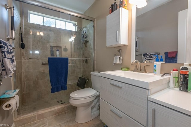 full bath featuring vanity, a stall shower, and toilet