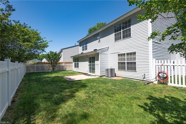 rear view of house with a lawn, a fenced backyard, a patio area, and cooling unit