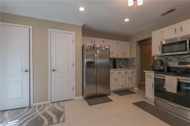 kitchen with white cabinets, stainless steel appliances, recessed lighting, tasteful backsplash, and visible vents