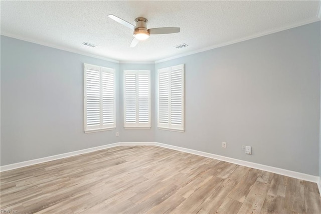 unfurnished room with crown molding, a textured ceiling, light wood-style flooring, a ceiling fan, and visible vents