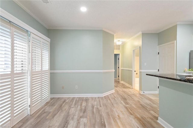 interior space with recessed lighting, baseboards, ornamental molding, and light wood-style floors