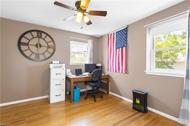 office area featuring a ceiling fan, baseboards, and wood finished floors