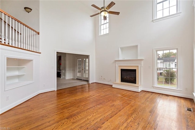 419 Hastings Pl, Suffolk, VA 23433 - unfurnished living room with built in features, a high ceiling, ceiling fan, and visible vents