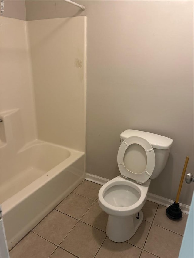 full bathroom featuring toilet, baseboards, and tile patterned flooring